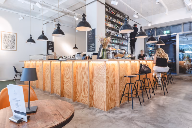 Helle Bar mit Holztheke und Sitzplätzen im L'Atelier Basel